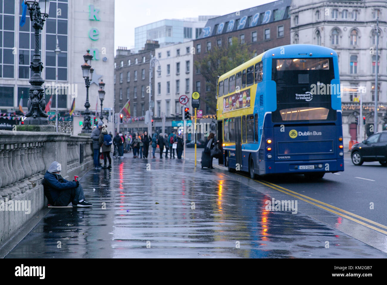 Dublin, Ireland. 3rd Dec, 2017. Homeless man begging on O`Connell bridge in Dublin on a rainy December day Stock Photo